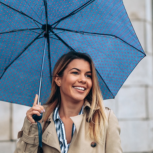 Smiling woman under an umbrella