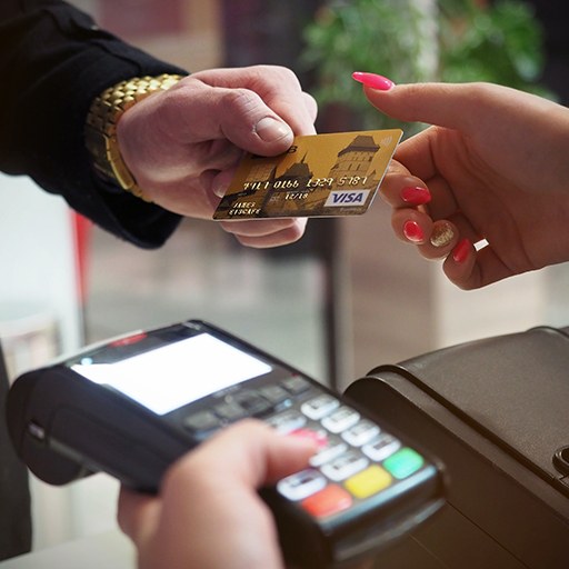 Man handing woman a credit card
