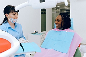 Female dental patient speaking with a dentist