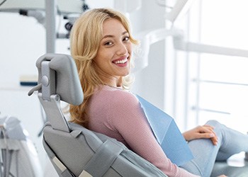 Patient smiling while sitting in treatment chair
