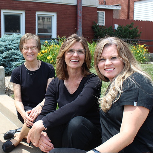 Three smiling dental office team members