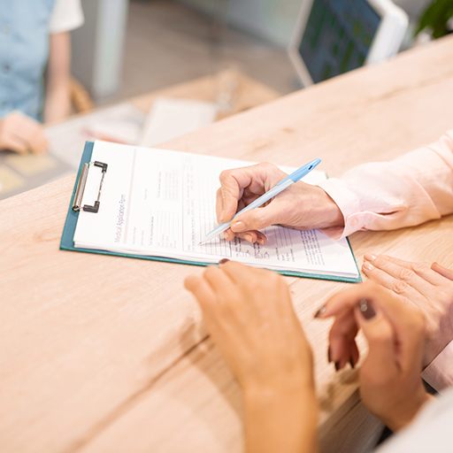 Dental patient filling out dental insurance forms