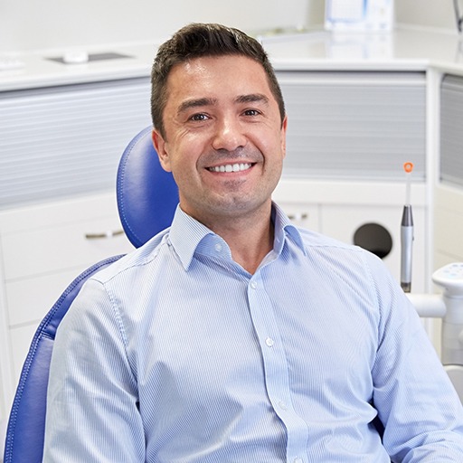 Man in dental chair smiling