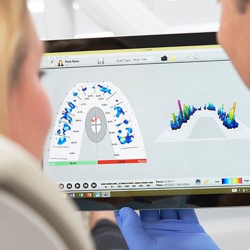 Dentist and patient looking at cavity detection system