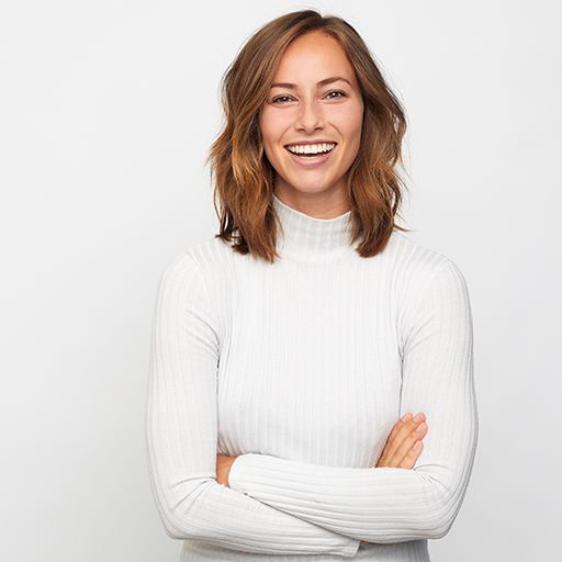 Woman in white sweater with brown hair smiling