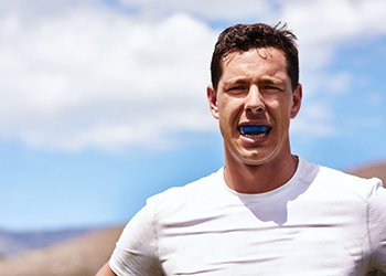 a man outside and wearing mouthguards