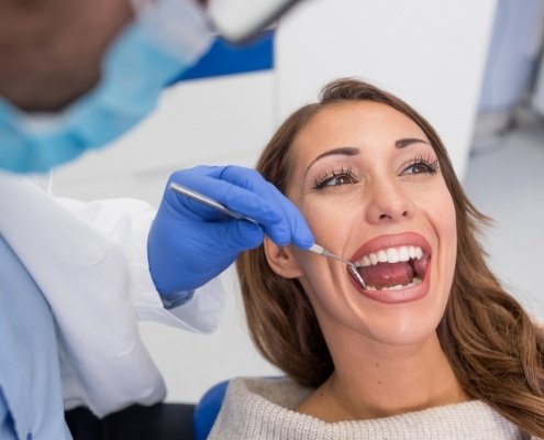 Woman receiving preventive dentistry exam