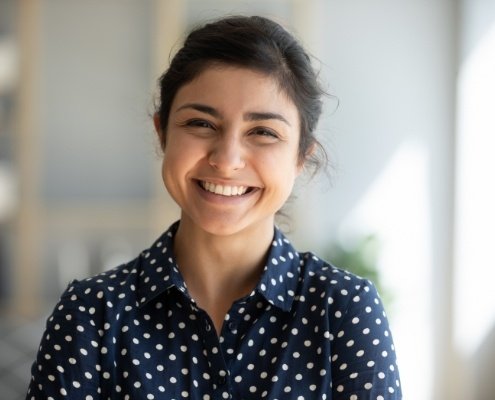 Woman with perfectly aligned smile after orthodontic treatment