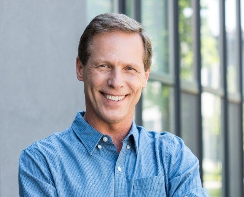 Man with flawless smile after replacing missing teeth