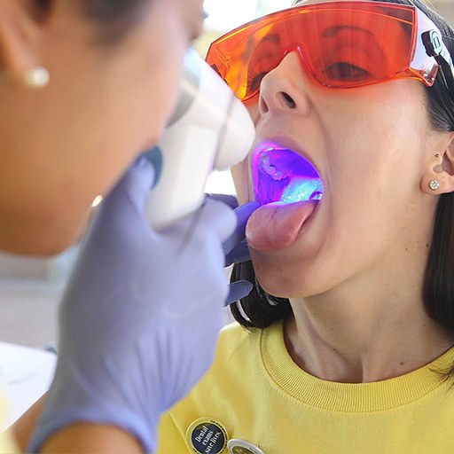 Dentist performing oral cancer screening