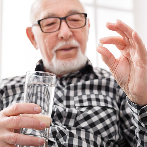 Man holding an oral conscious sedation dentistry pill