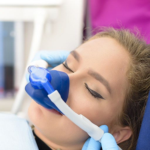 Relaxed woman with nitrous oxide dental sedation mask in place