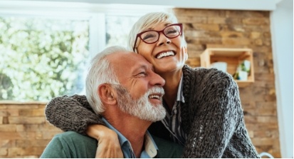 Man and woman laughing after restorative dentistry