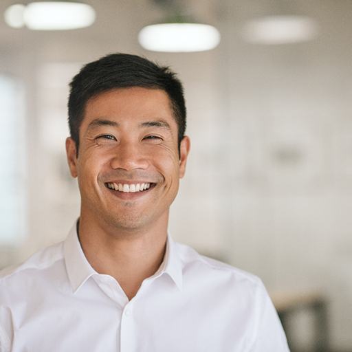 Man in white button-up shirt smiling