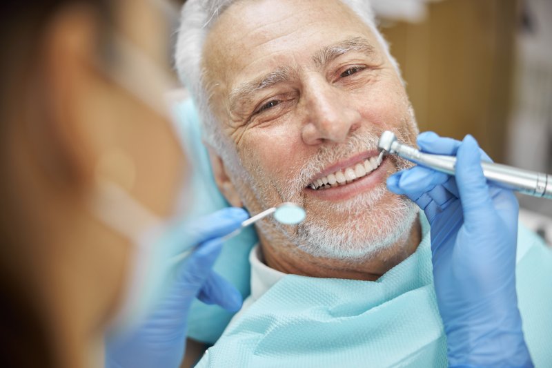 A senior man caring for his dental hygiene