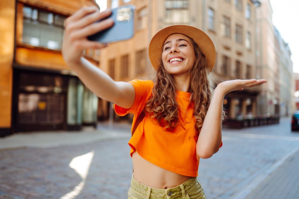 Woman smiling while taking a selfie on trip abroad