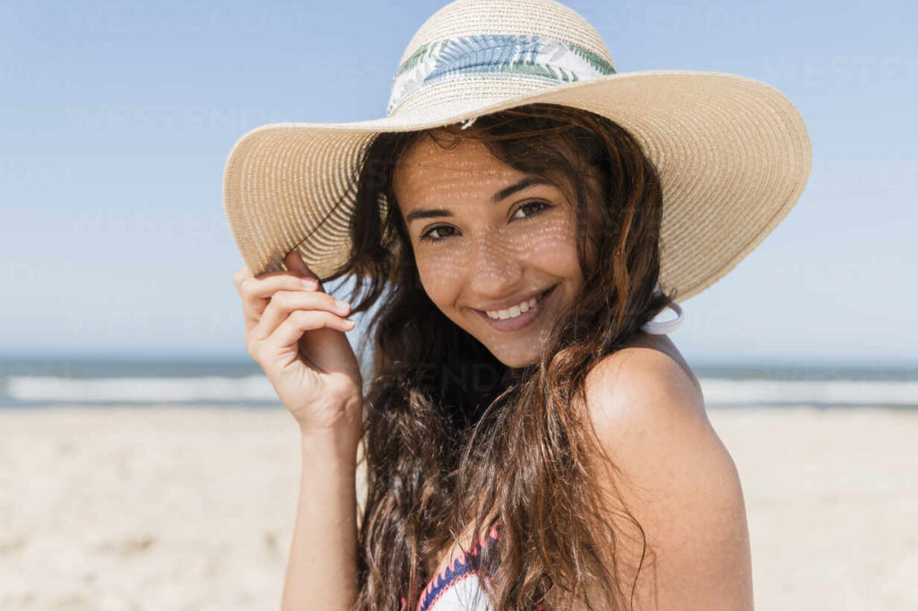 person on summer vacation smiling on a beach