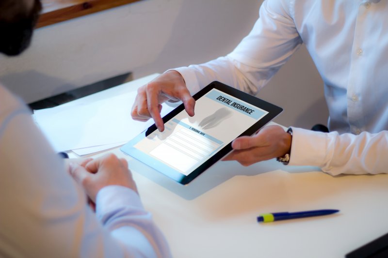 A dentist explaining dental insurance to a patient