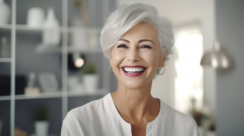 Older woman smiling with her dental implants